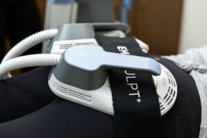 A close up of Emsculpt NEO applicators on a patient's glutes, used for core strengthening in Nags Head. When combined with Emsella, Emsculpt NEO can improve mobility and mind-to-muscle coordination.