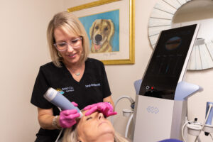A patient lays down as a provider performs facial rejuvenation near Kill Devil Hills.